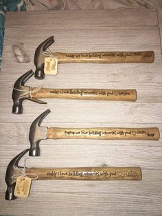 four hammers with engraved names on them