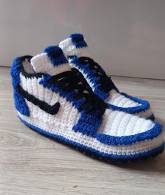 a crocheted blue and white sneaker with black laces