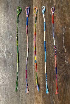 three toothbrushes are lined up on a wooden surface