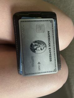 a woman's arm with an american express card on it