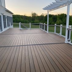 a large wooden deck with white railings