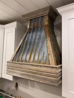 an old metal chimney hood hanging from the ceiling