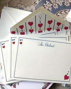 four cards with red hearts on them and the word, the wedding written in blue ink