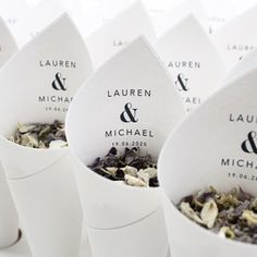 several cups filled with different types of teas and flowers on top of each other