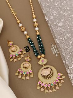 Description :- Gold Necklace, Indian Gold Necklace Set, Indian Choker, Pearl Necklace, Guttapusalu Necklace, Temple Jewelry, Jhumkas, South Indian Jewelry Gift yourself a royal look with this perfectly crafted kundan necklace set from Manalisstudio. Crafted with high quality kundan stones and pearls, it is impressive in design. The green enamel artwork adds perfect texture to the design. Perfect for weddings and festivities, this antique necklace set should be put on with your favorite sari or l Indian Gold Necklace Set, Gold Necklace Set Indian, Indian Gold Necklace, Guttapusalu Necklace, Choker Pearl Necklace, Choker Pearl, Indian Choker, Gold Necklace Indian, Necklace Set Indian