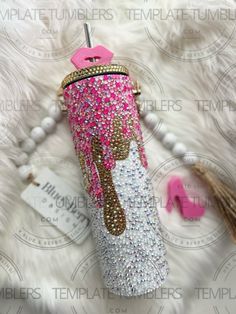 the pink and white umbrella is next to some beads on a fur rug with a tag