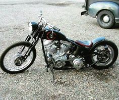 a motorcycle is parked in the parking lot next to a car and truck on the street