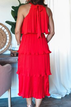 The Bella tiered dress is now back in a bright bold red! Style this beautiful maxi with the pearl belt. Fully Lined High Neck Midi Tired style midi can be styled with belt Pleated tiered Midi Elastic waist band Tie back closure Model is wearing a size Small. She is 5'6". 130lbs. Bust: 34C" Waist 26" Hips 36" Red Tiered Maxi Dress With Ruffles, Red Tiered Maxi Dress For Party, Red Tiered Midi Dress For Spring, Chic Red Tiered Dress, Red Tiered Maxi Dress For Spring, Red Tiered Skirt Maxi Dress For Spring, Elegant Red Tiered Midi Dress, Red Tiered Ruffle Maxi Dress, Red Tiered Ruffle Midi Dress