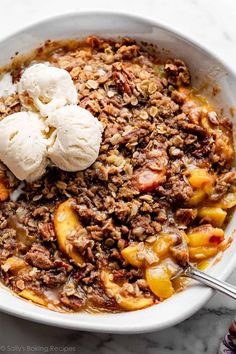 a white bowl filled with fruit and ice cream