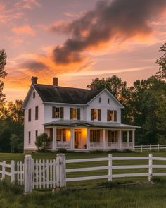 a large white house sitting on top of a lush green field