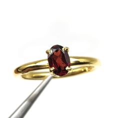 A gold-plated 925 silver ring adorned with a garnet gemstone is not only a stunning piece of jewelry but also carries significant birthstone specialties and healing properties. Garnet, the birthstone for January, is renowned for its deep red hue and multifaceted benefits. In terms of birthstone specialties, garnet is believed to enhance qualities associated with Capricorns and Aquarians, such as loyalty, trustworthiness, and self-discipline. It's said to bring good fortune and success to those born in January, encouraging them to pursue their goals with determination. From a healing perspective, garnet is thought to promote physical vitality and stamina, making it an ideal companion for those needing an energy boost. It's also considered a powerful emotional healer, assisting in the releas Gold Garnet Birthstone Ring, Gold Oval Garnet Birthstone Ring, Fine Jewelry Gold Garnet Rings, Gold Garnet Rings Fine Jewelry, Adjustable Garnet Ring, Gold Garnet Birthstone Ring Gift, Gold Garnet Open Ring, Yellow Gold Garnet Rings With Prong Setting, Yellow Gold Garnet Rings For Gifts