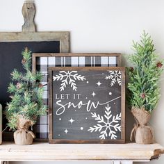 christmas decorations on top of a mantle with a sign