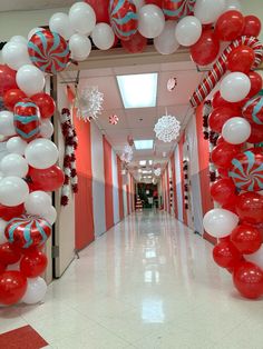 a hallway decorated with red, white and blue balloons for an office christmas party or graduation