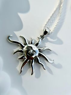 Illuminate your style with our Sterling Silver Boho Style Sun Pendant, beautifully paired with a whimsical popcorn link chain. The sun symbolizes warmth, positivity, and vitality, while the boho-inspired design adds a touch of free-spirited charm. Crafted from high-quality sterling silver, this necklace exudes both durability and timeless elegance. Perfect for adding a radiant glow to any outfit, it's a versatile piece that transitions effortlessly from day to night. Metal: 925 Sterling Silver. Summer Gift Jewelry With Sun And Moon Design, Sun And Moon Design Jewelry As Summer Gift, Sun And Moon Design Jewelry For Summer, Summer Sun Design Jewelry Gift, Silver Celestial Necklace With Sun Design, Spiritual Silver Necklace With Sun Design, Silver Sun Necklace With Sun And Moon Design, Celestial Sterling Silver Necklace With Sun Design, Silver Necklace With Sun And Moon Design