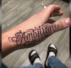 someone is holding their arm with the word annitition on it in cursive writing