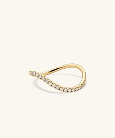 a yellow gold ring with white diamonds on the sides and a curved band in the middle