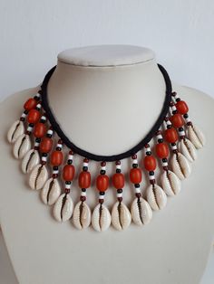 OOAK Vintage tribal Papua New Guinea cowrie shell bib waterfall necklace with dangle fringes with nice cut cowrie shells, black and white glass seeds and coral glass barrel beads on black cotton cord. The necklace shall be knotted behind the neck in order to wear it.  Cord : 20 inches; fringes: approx. 2 inches. Good vintage condition - sold as is. Free combined shipping offered where possible on jewelry - please contact us before purchase to arrange the pricing.  IMPORTANT TO READ: To make this Cowrie Shell Jewelry Necklaces, Cowrie Shell Jewelry, Waterfall Necklace, Cowrie Shells, Seashell Jewelry, Beaded Jewelry Tutorials, Bib Necklaces, New Guinea, Handmade Jewelry Designs