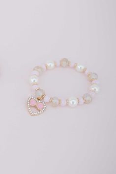 "Our NEW Boutique collection boasts a meticulously curated selection of necklaces, bracelets, headbands and hair accessories. The Boutique Love bracelet is one of our most elegant bracelets yet! Strung with pink, white, and gold beads and finalized with a rhinestone incrested heart & bow charm. This bracelet is so sweet, it even has a matching necklace! I design all costumes and accessories & have developed a patterning process for ultimate sizing flexibility. Due to our lucky growth over the pa Bracelet For Kids, Bracelets Pink, Packaging Jewelry, Jewelry Heart, Kids Bracelets, Boutique Collection, Love Bracelet, The Boutique, Elegant Bracelet