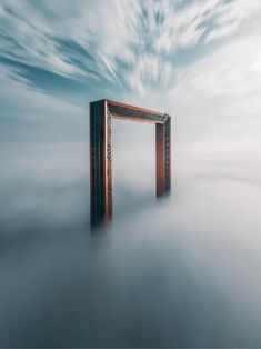 a wooden frame in the middle of some fog