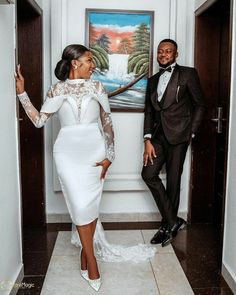 a man and woman in formal wear standing next to each other