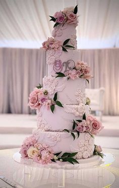 a three tiered wedding cake with flowers on it