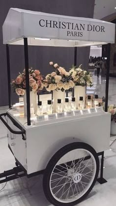 an ice cream cart with flowers and candles on the front is shown in this photo