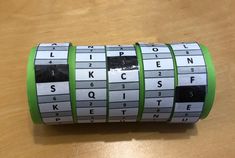 a close up of a roll of tape on a table with letters and numbers printed on it