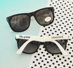 two black and white sunglasses with the word groom written on them, sitting next to each other