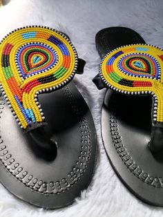 100% handmade using leather and fine beads. Masai beaded sandals are made using the pure original leather and quality African beads.They are inspired by the Masai community They are perfect for any occasion. True to size. We ship worldwide. Feel free to send me a convo for any clarifications Traditional Toe Loop Sandals For Vacation, Traditional Beach Slippers For Summer, Traditional Open Toe T-strap Sandals For Vacation, Traditional Toe Post Flip Flops For Summer, Leather Open Toe Flip Flops For Festivals, Handmade T-strap Sandals With Toe Post For Vacation, Traditional Round Toe Barefoot Sandals For Beach, Traditional Open Toe T-strap Sandals For Beach, Bohemian Handmade Toe Post Flip Flops