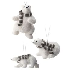 three stuffed polar bears hanging from strings