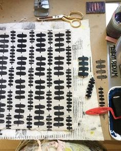 the fabric is being made with scissors and other crafting supplies on top of a table