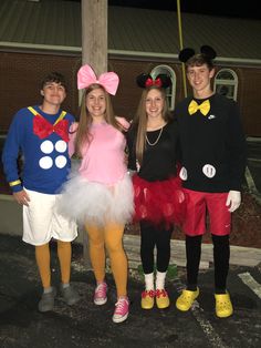 three people dressed up as mickey mouse, minnie mouse and donald the pooh are standing next to each other