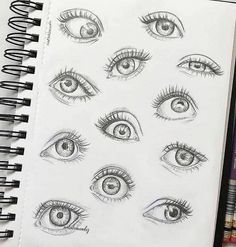 an open notebook with drawings of different eyes