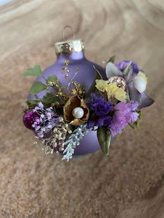 an ornament filled with flowers on top of a table