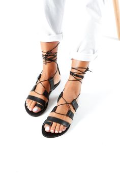 Black Greek Sandals, Lace Up Sandals, Gladiator Sandals, Handmade Leather Shoes, Greek Leather Sandals, Spartan Shoes, NEFELI NEFELI SANDALS Gladiator Leather sandals with straps and leather rope NATURAL color / BLACK Color Handmade sandals Leather straps and insole Rubber anti-slippery outsole All our sandals are inspired from the ancient grecian style and are made of the finest greek leather. Each pair is handmade by the most experienced craftsmen using the traditional greek techniques to ensure elegance and durability. Genuine leather can present small imperfections and variations of colour due to the nature of the material. That adds uniqueness on every pair. Leather is a flexible, breathable material.  Note that natural leather darkens with time. DHL EXPRESS WORLDWIDE  FAST AND RELIAB Leather Strappy Barefoot Sandals For Festival, Strappy Leather Barefoot Sandals For Festivals, Leather Toe Loop Lace-up Sandals For Vacation, Leather Strappy Sandals For Festivals, Adjustable Leather Lace-up Sandals For Festivals, Festival Lace-up Toe Post Sandals, Adjustable Toe Post Lace-up Sandals For Festivals, Leather Lace-up Sandals With Closed Toe For Festival, Adjustable Lace-up Open Toe Sandals With Leather Sole