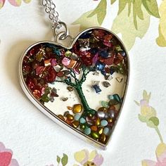 Silver Toned Heart Tree  Necklace Pendant Resin  Heart Shaped  Colorful Pebbles as Leaves  Green Wire Leaves for Branches  18 Inch Chain Silver Plated Chain Lobster Clasp Closure Comes in Gift Box and Organza Gift Bag Ships within 3 days. Will ship first class mail.  See our shop Hello Emiko for more beautiful handmade jewelry and gifts. Whimsical Heart-shaped Necklaces For Gifts, Handmade Green Heart Shaped Necklace, Resin Heart Charm Necklace Gift, Handmade Resin Necklaces With Nature-inspired Style, Valentine's Day Heart-shaped Resin Necklace, Heart Shaped Jewelry, Heart Tree, Tree Necklace, Organza Gift Bags