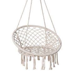 a white hanging chair with tassels