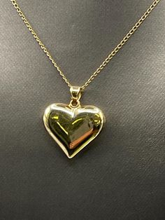 Designed and crafted in 14 karat solid yellow gold.  This classically designed puffed heart pendant looks beautiful worn on your favorite chain.   Weight:  1.5 grams  Length:  1" Width: ⅞" Our Price $219.00 Regularly Priced At $425.00 Please See Our Video Remember - If you're purchasing for yourself or a gift for a loved one, buy with confidence.  We Guarantee Everything We Sell!  SKU # P647 Classic 14k Gold Double Heart Necklaces, Classic Double Heart 14k Gold Necklaces, Formal Heart Charm Jewelry With Heart Pendant, Formal Heart Pendant Jewelry With Heart Charm, Classic 14k Gold Open Heart Necklace, Gold 14k Locket Heart Necklace, Gold Heart Locket Necklace In 14k Gold, Gold Heart Locket Necklace 14k, Classic Jewelry With Heart Charm And Heart Cut