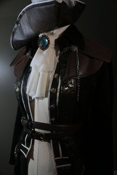 Become Lady Maria from the action packed game Bloodborne! Our jacket is handcrafted and made to fit every individual! The jacket is inspired by the character and made from high quality fabrics, including knits, silks, and faux leather. The jacket is made as one single piece, (jacket, undershirt, skirt, and caplet) so that it is easy to put on and ready for wear as soon as you receive it! (Listing does not include chain, scarf, belts, or hat) Lady Maria Cosplay, Bloodborne Outfits, Bloodborne Cosplay, Gothic Fashion Victorian, Lady Maria, Chain Scarf, Custom Costumes, Bloodborne, Nerd Geek