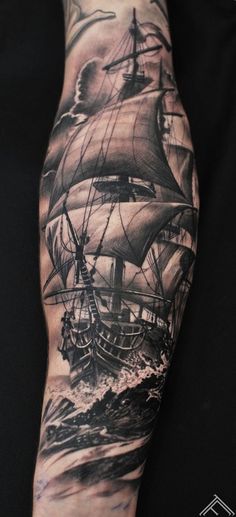 a man's arm with a ship on it