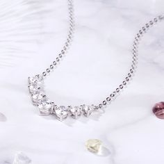 Create a wonderful memory when you present this glimmering necklace to the one you love. Regal and radiant, this necklace is perfect for that special evening out. It showcases seven shimmering round stones, graduating from smallest to largest to smallest, are arranged in a clever chevron pattern, creating this eye-catching style. Carat Weight: 1.5 ctStone Size: 6 mmStone Type: Jeulia® StoneNumber of Stones: 1 Stone Color: Diamond WhiteStone Shape: RoundCarat Weight: 2.71 ctStone Size: 5,4,3 mmSt Elegant Cubic Zirconia Rhinestone Necklace For Valentine's Day, Dazzling Sparkling Rhinestone Necklace For Anniversary, Sparkling Rhinestone Necklace For Anniversary, Anniversary Sparkling Crystal Diamond Necklace, Sparkling Necklace For Anniversary, Valentine's Day Sparkling Cubic Zirconia Necklaces, Valentine's Day Sparkling Cubic Zirconia Necklace, Cubic Zirconia Necklaces For Mother's Day Party, Sparkling Diamond Necklace For Anniversary