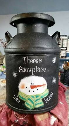 there is a black pot with a snowman on it