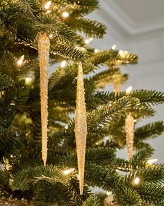 a close up of a christmas tree with lights on it and ornaments hanging from the branches