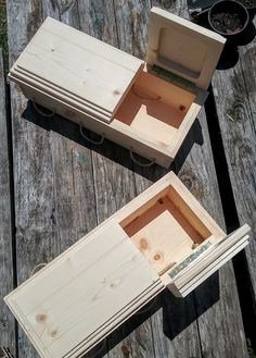 two wooden boxes sitting on top of a wooden table