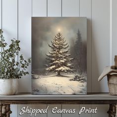 a painting of a snowy pine tree on a shelf