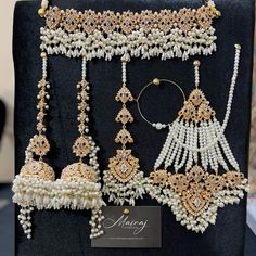 an assortment of white and gold jewelry on display