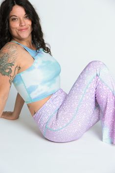 The Teeki Mermaid Tanks are cut with a high neckline and razor back crop top. They can be layered and offer gentle compression for low-impact workouts, yoga, swimming, and everyday layering. Fit: The single layer of lightweight fabric offers a gentle compression for low impact activities and daily use. Move freely in yoga class, by the pool, in the ocean, or layering without the discomfort of tight elastic bands, thick materials and underwires. If you have a small chest size the fit may not be t