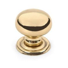 an antique brass knob with black stripe on the top and bottom, is shown in this image