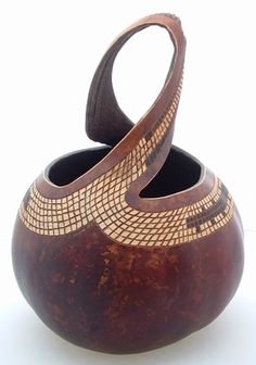 two wooden vases sitting side by side on a white surface