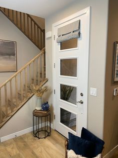 a living room with a chair and stairs